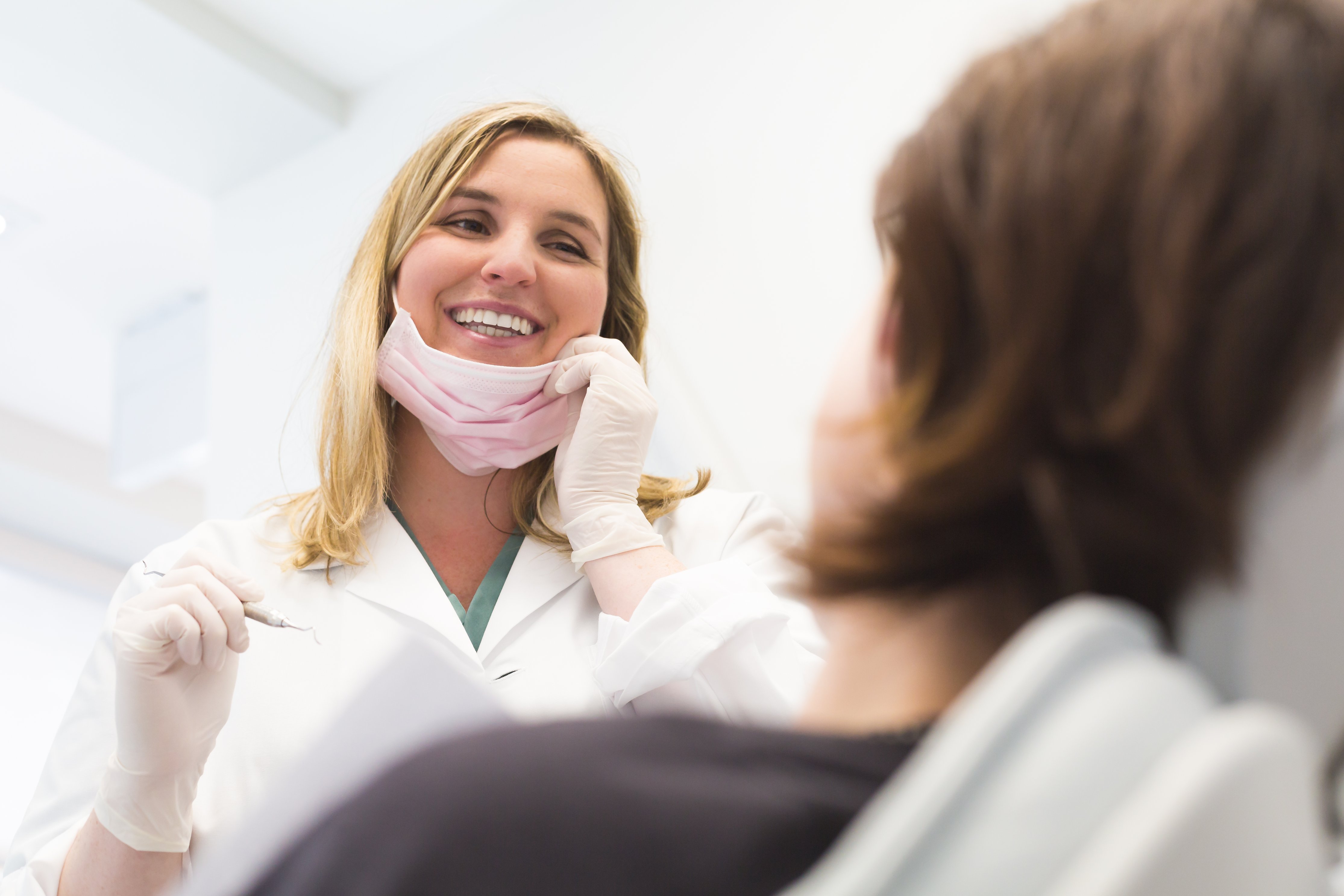 Female oral health therapist smiling at the patient