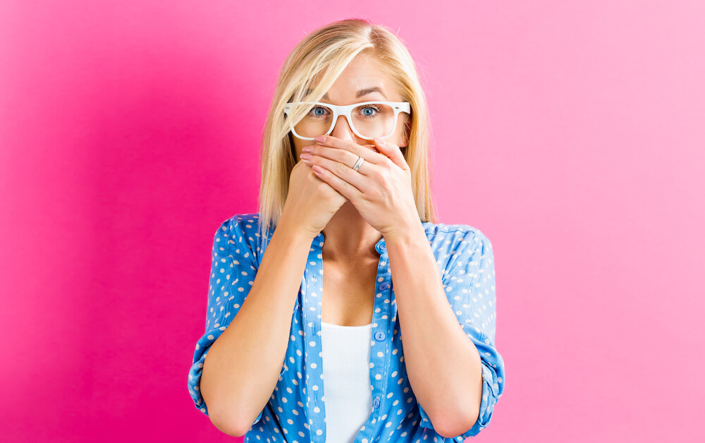 woman covering her mouth with her hands