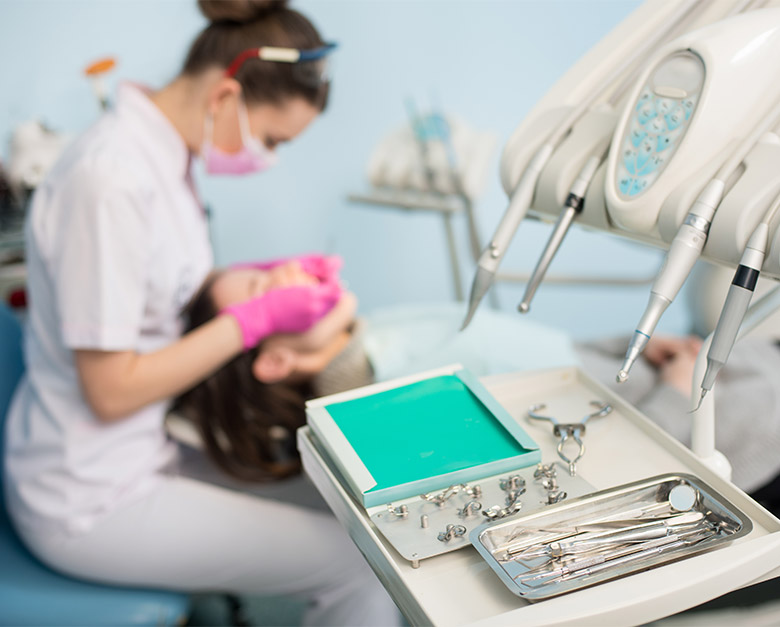 female dentist treating female patient